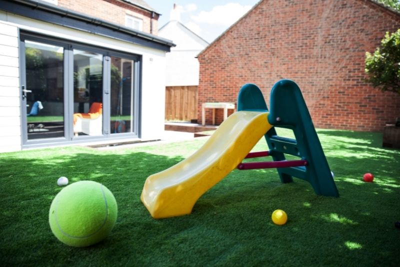 backyard kids playground with fake lawn